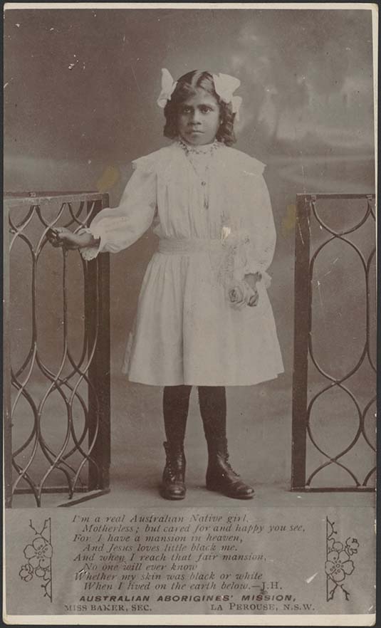 Black and white photo of an Aboriginal girl dressed in white clothing