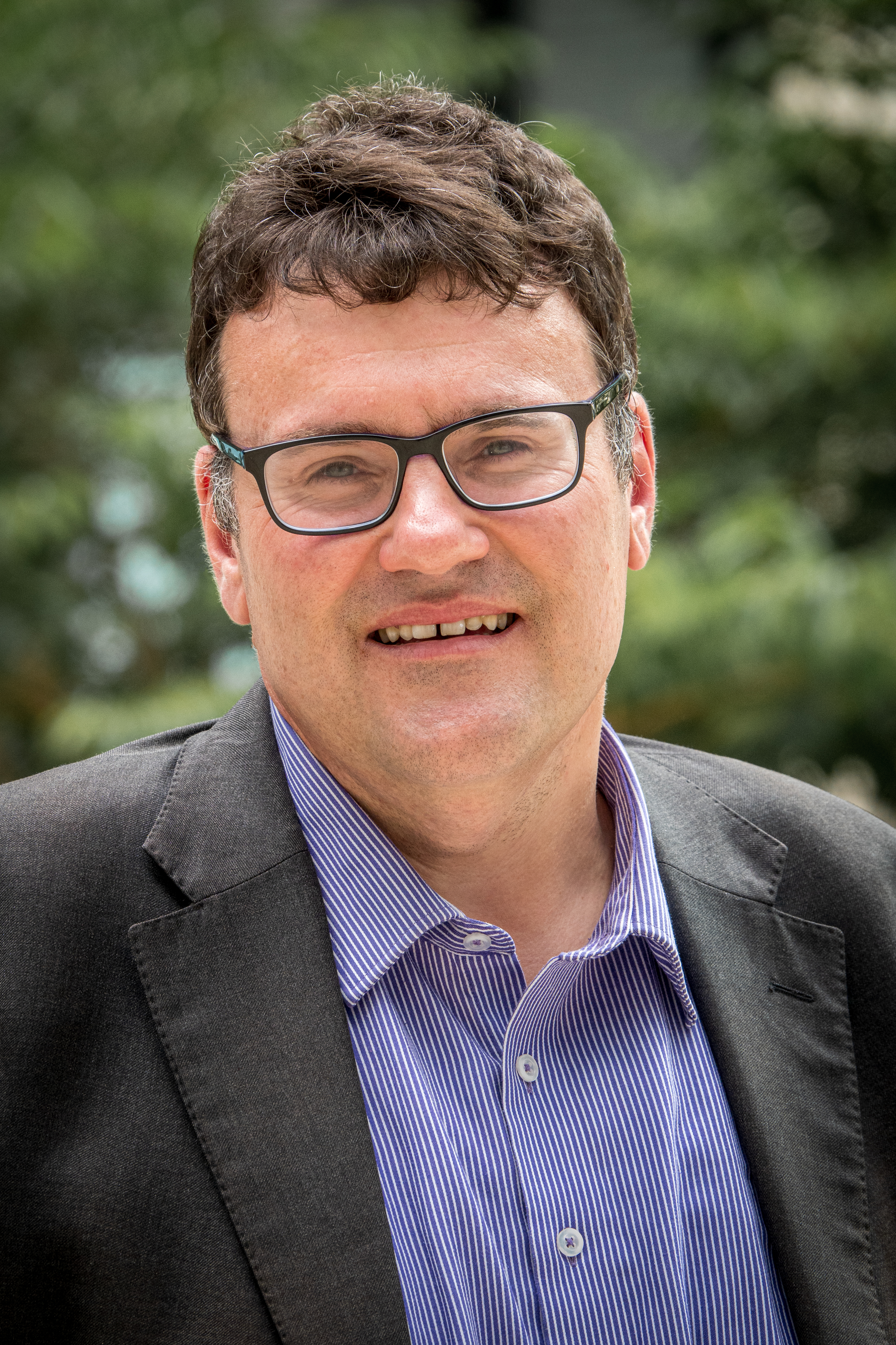 Frank Bongiorno, wearing a blue shirt, black jacket and glasses