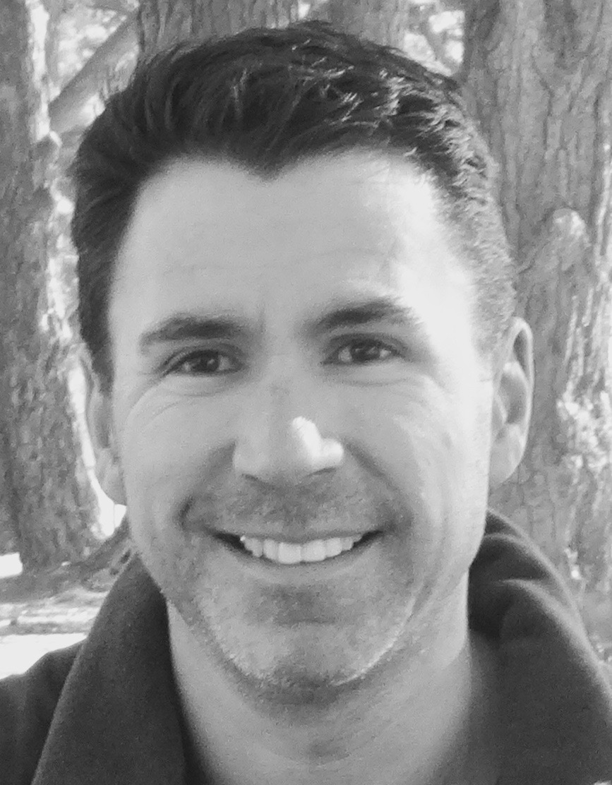 A close up black and white photo of author Daniel Oakman