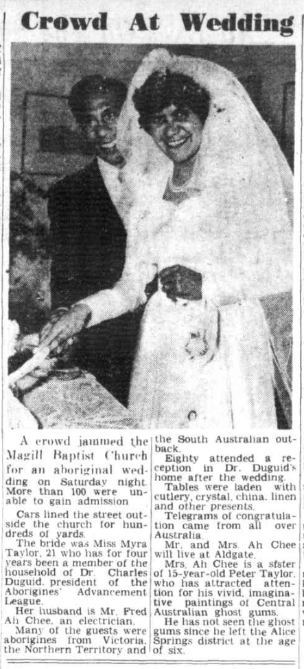 Newspaper article titled 'Crowd At Wedding' with a black and white photo of a First Nations couple smiling and cutting cake, with a short description of their wedding