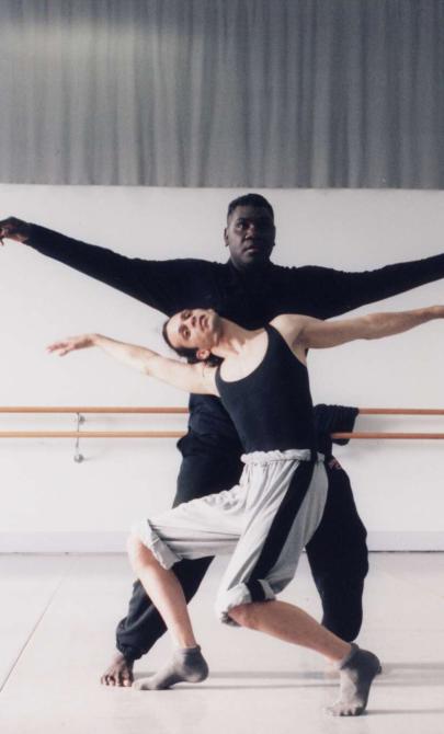 A man and a woman hold a dance pose