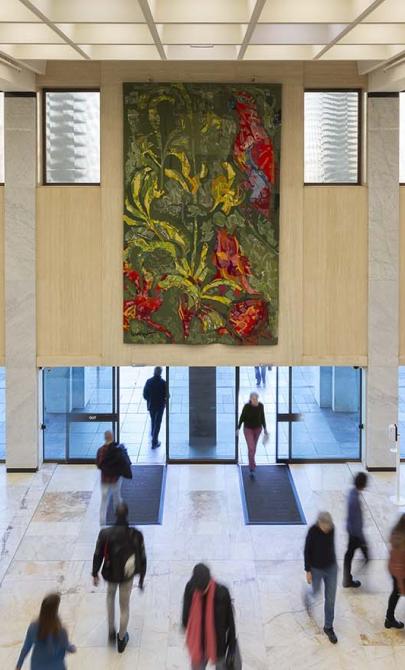 Three colourful tapestries hanging above the main entrance doors