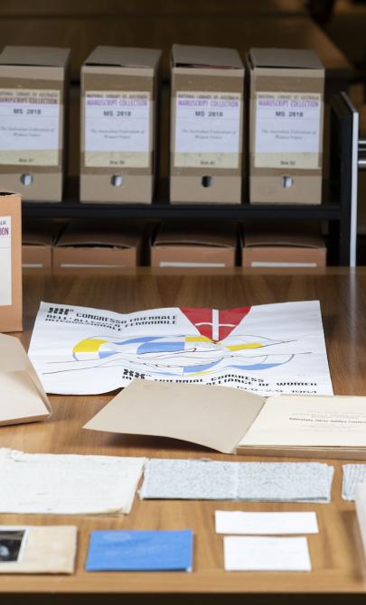 Cardboard boxes and manuscript material spread over a large table