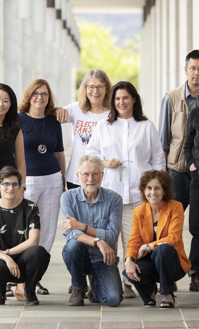 Eleven people posed for a photo under the National Library's exterior colonnade.