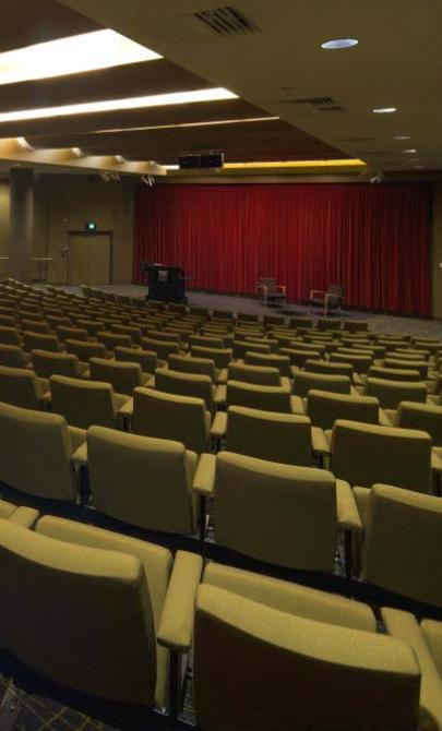 An theatre with seats and a podium but no people