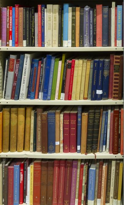 Large wall of bookshelves with hundreds of colourful books