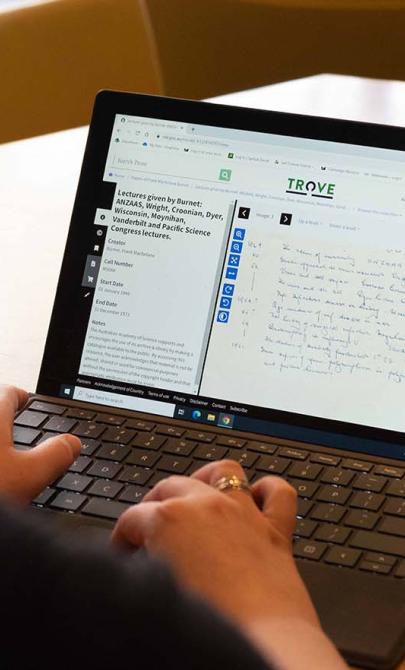 Person looking at the Trove website on a laptop