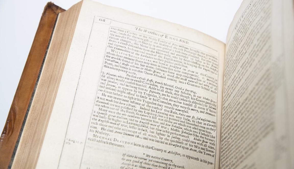 Old book open to page with lots of small text