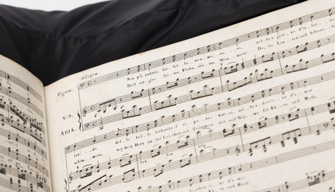 Printed music score (partial view) sitting on a black cushion