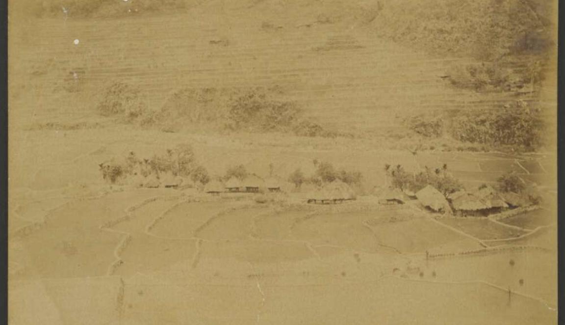 Faded sepia image of rice fields and rice terraces in a small village