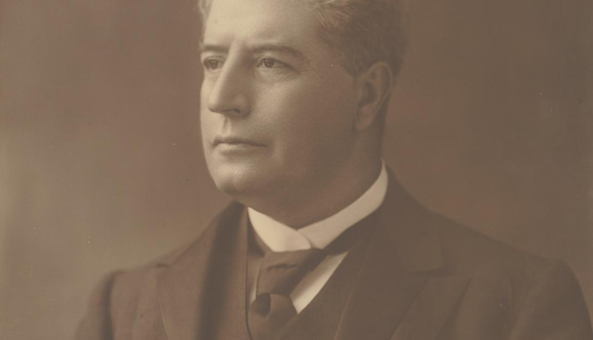 Portrait of a man with light, slightly wavy hair in a three piece suit