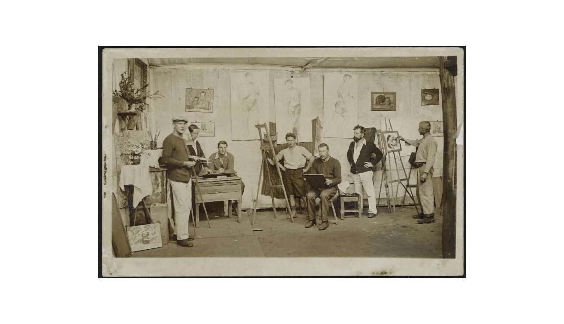 Seven men painting in an art studio