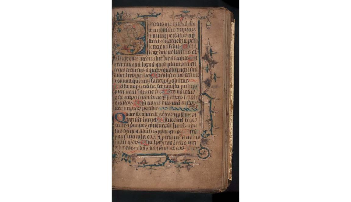 A very old document. It is handwritten. The text is in Latin and is written in black. The page is illuminated with stylised plants and vines. The first letter on the page is a "B". It is large and highly decorated.