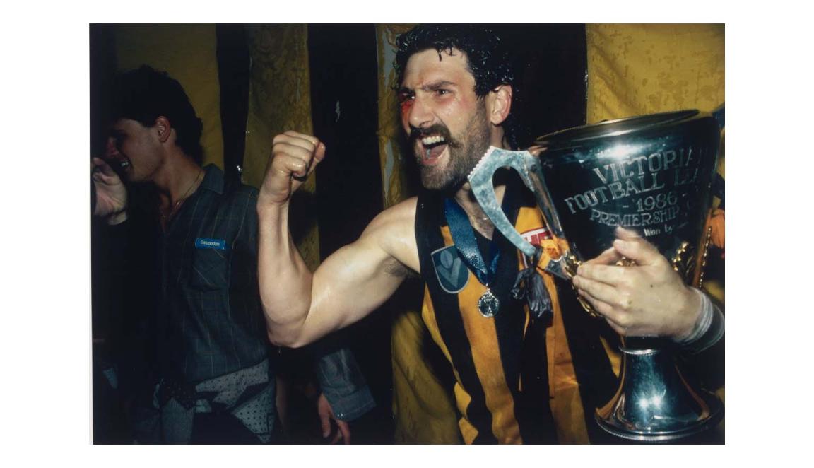 Photo of Robert Dipierdimenico holding a trophy and cheering