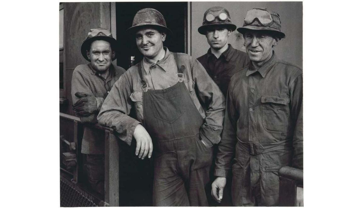 black and white photograph of four miners