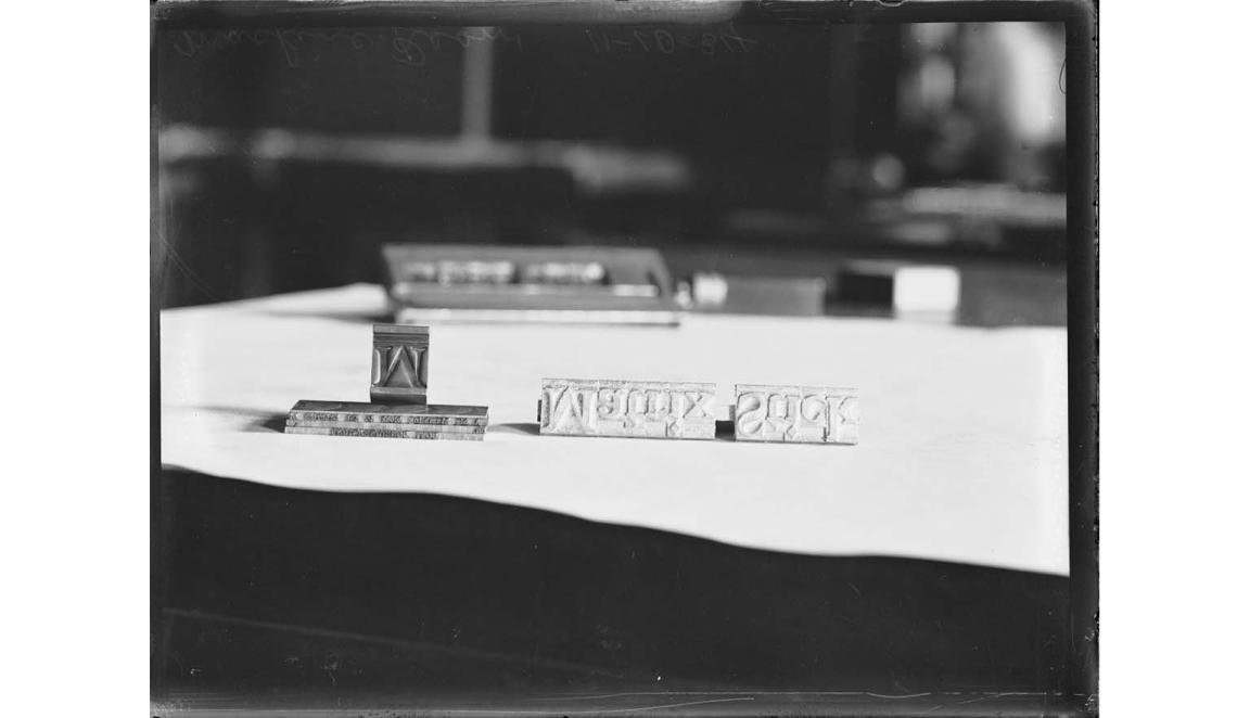 A black and white image of type letters on a piece of paper. The letters spell out 'Matrix Stick' backwards and upside down.
