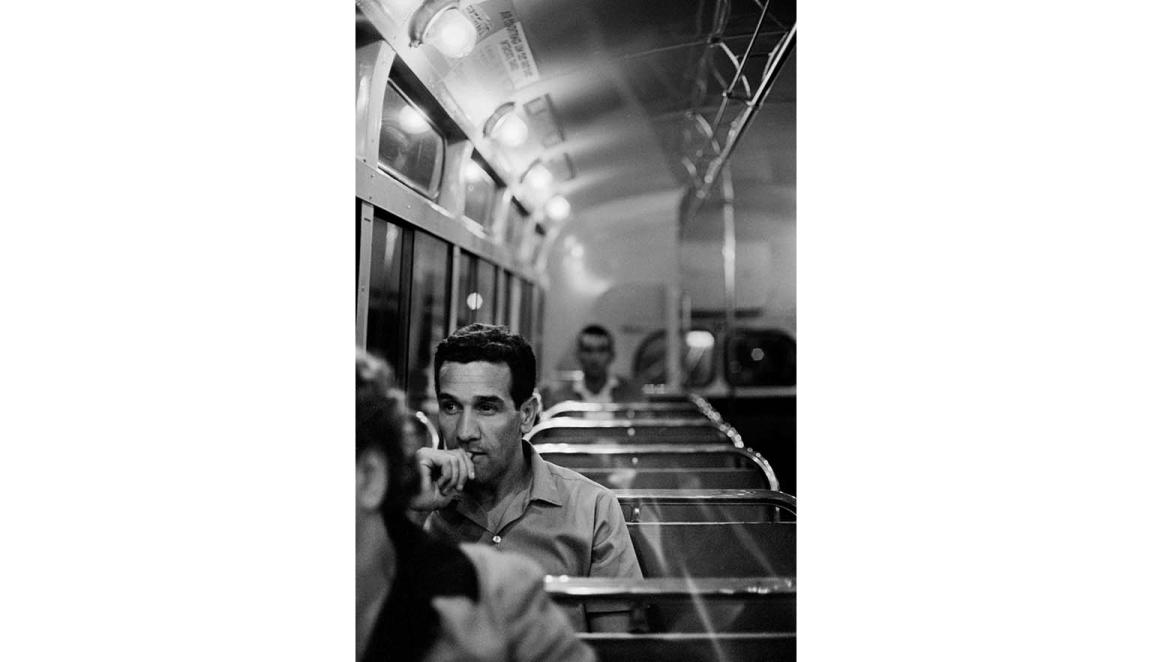 black and white photo of young man on bus