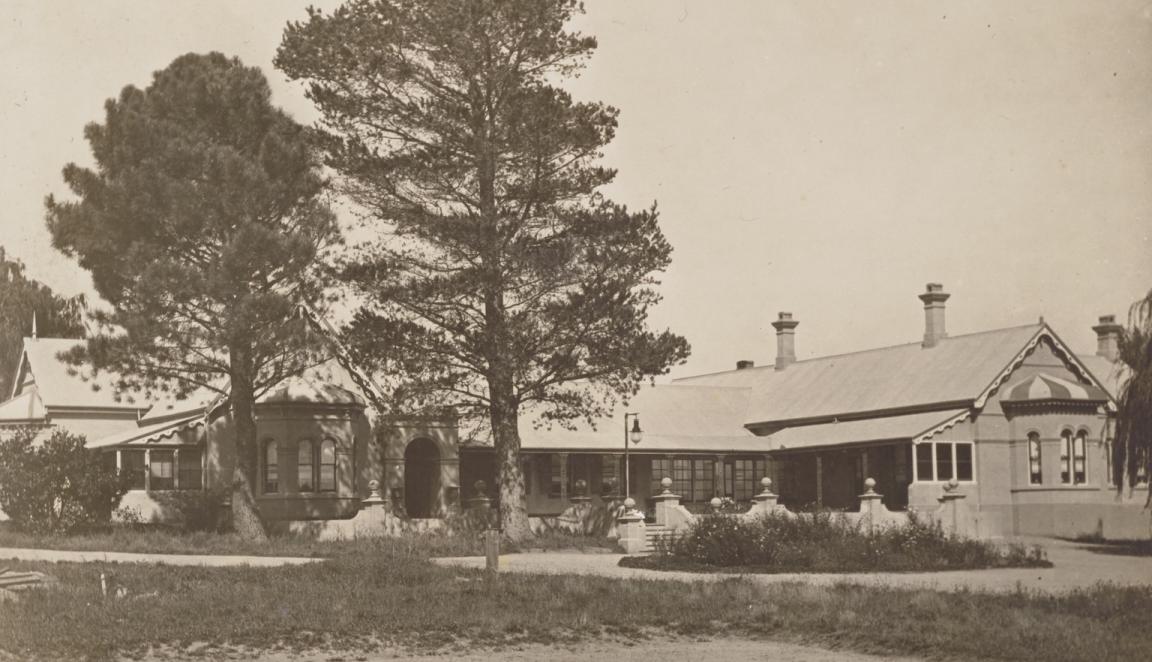 Sepia-toned photograph of a large house
