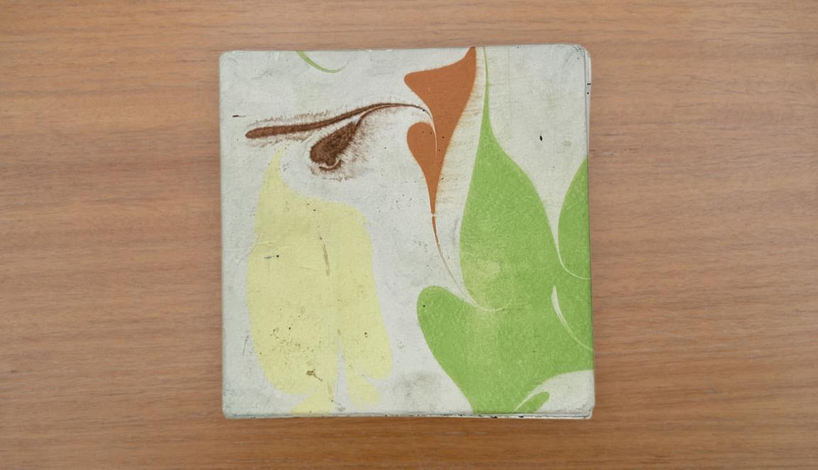 Travel diary back cover with an abstract green, yellow, orange and white design