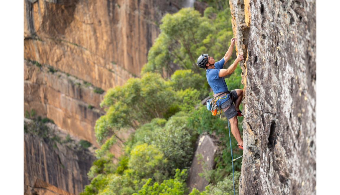 Male mountain climber on a steep rocky cliff face