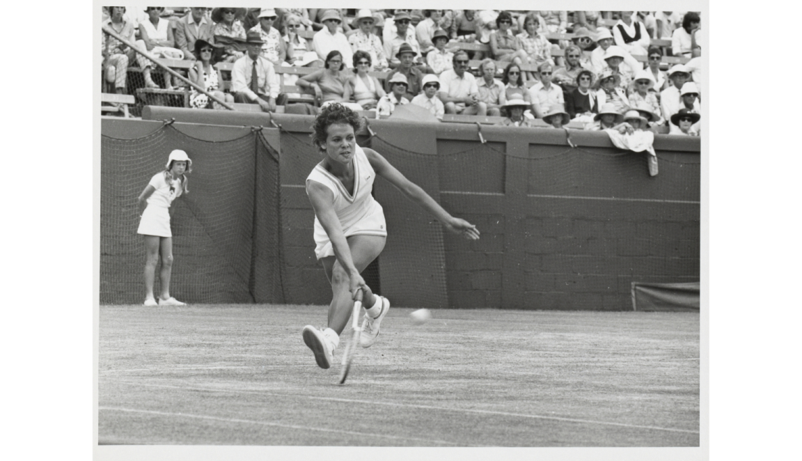 A black and white photograph with Evonne Goolagong playing a tennis shot