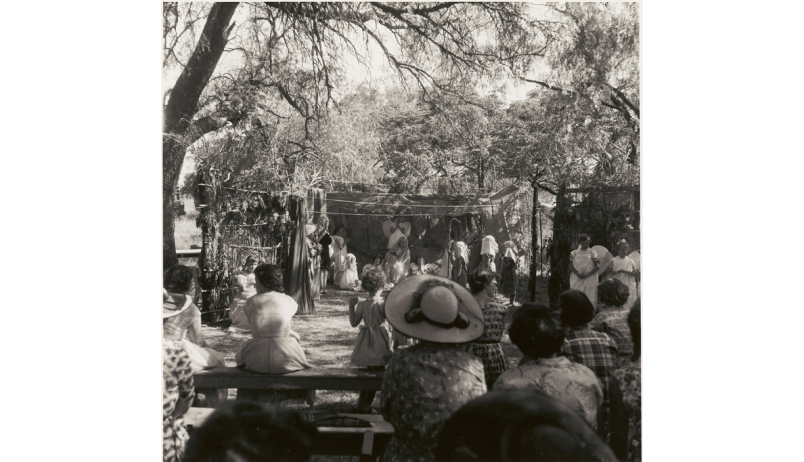 Black and white photo of school children putting on a nativity play to a large audience 