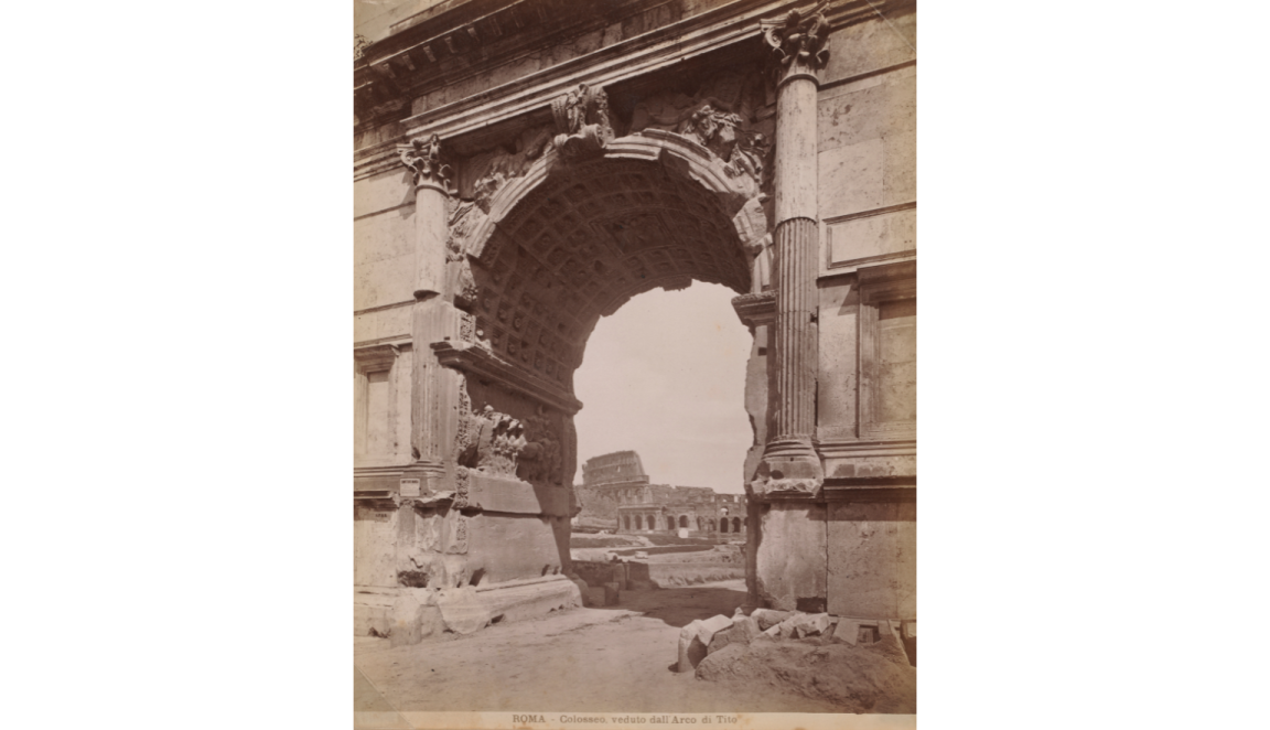 A sepia toned photograph showing the ruins of the Colosseum viewed through the ruins of the Arch of Titus. At the bottom of the photo are words in Italian: 'ROMA - Colosseo, verduto dali Arco di Tito'