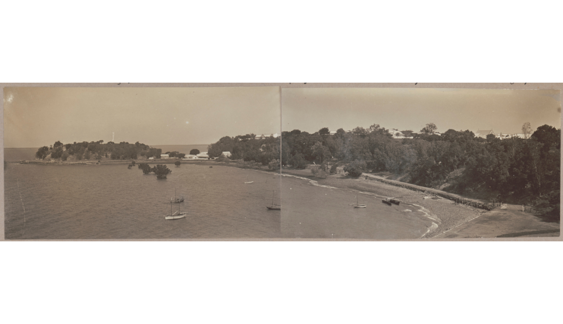 Long sepia-toned photograph with a fold line down the middle of a beach in the Northern territory with small boats in the water