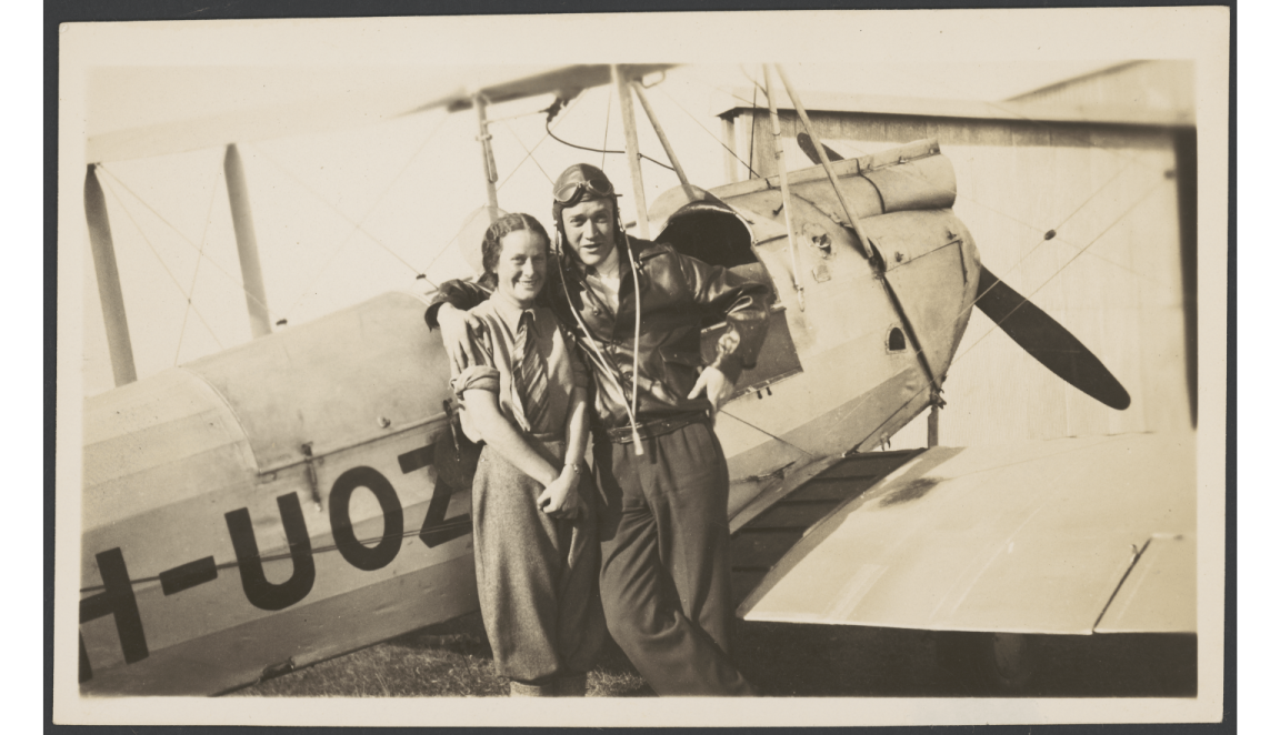 Black and white image Nancy Bird and Jack Kingsford-Smith standing in front of an aeroplane