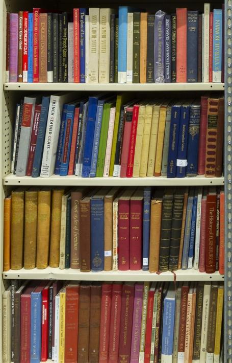 Large wall of bookshelves with hundreds of colourful books