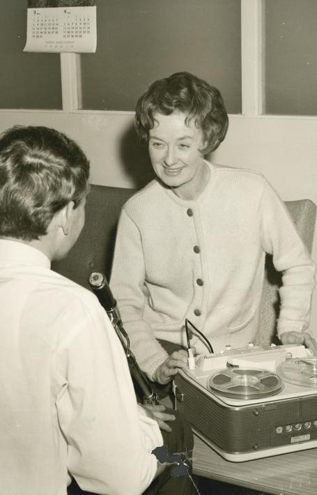 Sepia-toned photo of oral historian Hazel de Berg smiling while interviewing Michael Terry