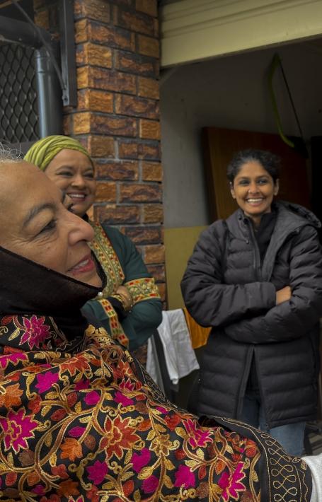 Woman greeting man outside house for Celebration of Eid al-Adha