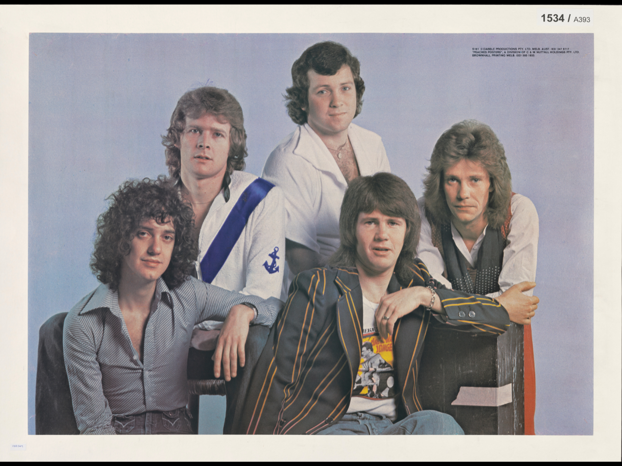 Musical band Sherbert posing in front of a plain blue background