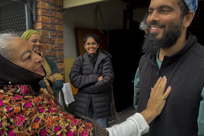 Woman greeting man outside house for Celebration of Eid al-Adha
