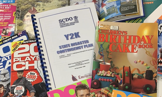 Magazines and books from the 00s and 90s spread out, including the 'Australian Women's Weekly: Children's birthday cake book' and a document titled 'Y2K: State disaster contingency plan'