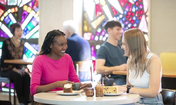 Two young women having morning tea at the Bookplate cafe