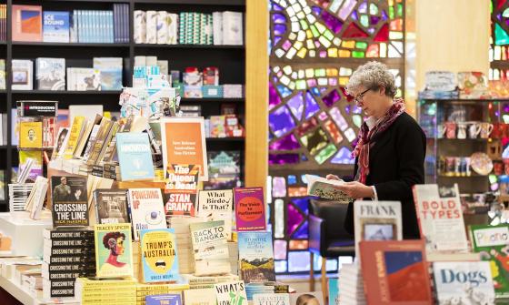A woman looking at a book in a bookshop