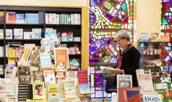 Woman browsing books on display at the Library's Bookshop