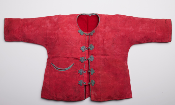 Small red christening gown with black buttons down the centre