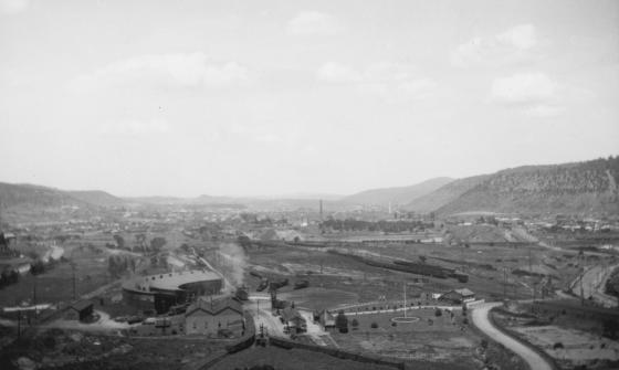 Black and white image of factories and other industrial buildings in a valley