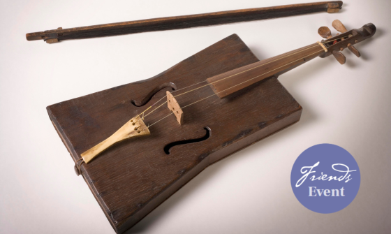 A violin and bow crafted from a stockman's tucker box and a purple sticker signalling that this is a Friends of the Library event.