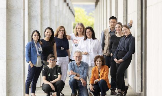 Eleven people posed for a photo under the National Library's exterior colonnade.