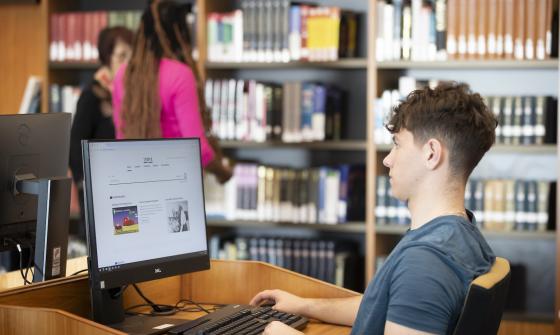 Young man browsing Trove on a computer in the Main Reading Room