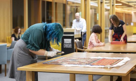 People looking at collection material and moving around the Special Collections Reading Room 