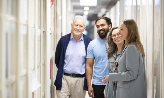 Tour guide taking three people through the Library's stacks