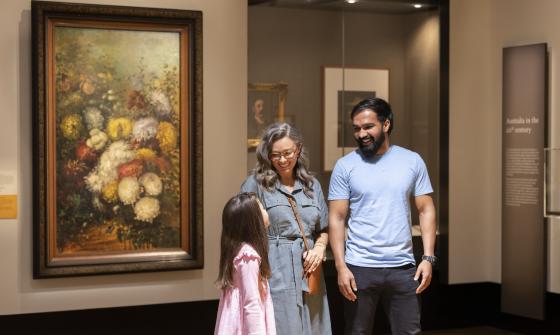 Parents and child smiling and talking in the Library's Treasures Gallery