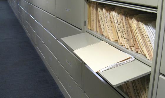 Files of newspaper clippings in a cabinet