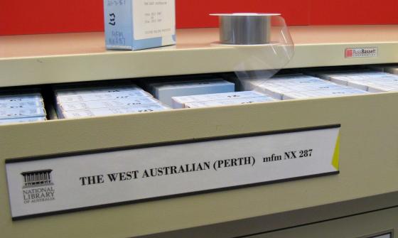 An open drawer filled with microfilm newspapers of 'The West Australian (Perth)'