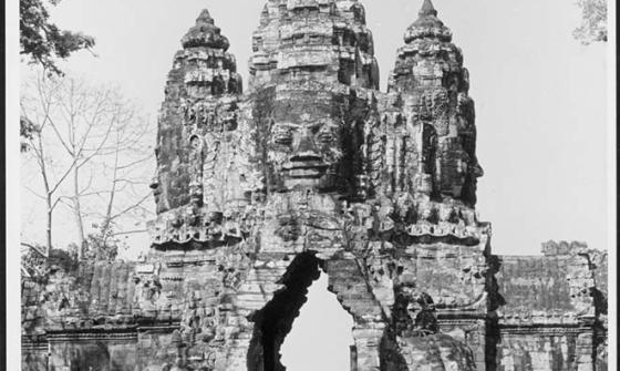 A black and white photograph of Khmer Temple gate surrounded by trees