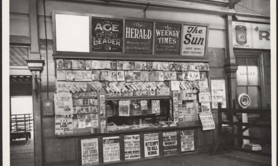 A newspaper stand with headlines about an attempt to kill the King